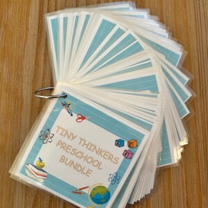 May include: A blue and white printable preschool activity bundle with the title "Tiny Thinkers Preschool Bundle". The bundle includes a variety of activities for preschoolers, such as alphabet blocks, a globe, pencils, and scissors.