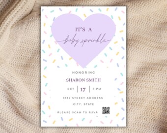 May include: A baby sprinkle invitation with a lavender heart and colorful confetti. The text reads "IT'S A baby sprinkle" and includes details for Sharon Smith's event on October 17th at 1 PM. Includes address and RSVP instructions.