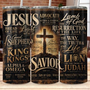 May include: A set of three stainless steel tumblers with a black background and religious text. The tumblers feature phrases like "Jesus," "Advocate," and "Lamb of God." Each tumbler has a white straw.