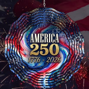 May include: A decorative, layered ornament with the text "AMERICA 250 1776-2026" in gold. The ornament features a swirling design in red, white, and blue, with a background of the American flag and fireworks.