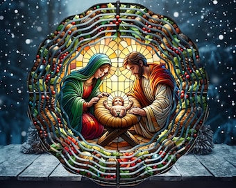 May include: A circular metal wind spinner featuring a stained glass style nativity scene. The design depicts a central infant in a manger with two figures in robes, surrounded by a decorative border of green holly leaves, red berries, and pinecones.