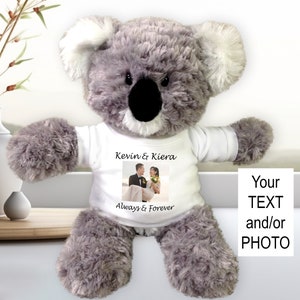 May include: A gray koala plush toy wearing a white t-shirt with a photo of a couple and the text "Kevin & Kiera Always & Forever".