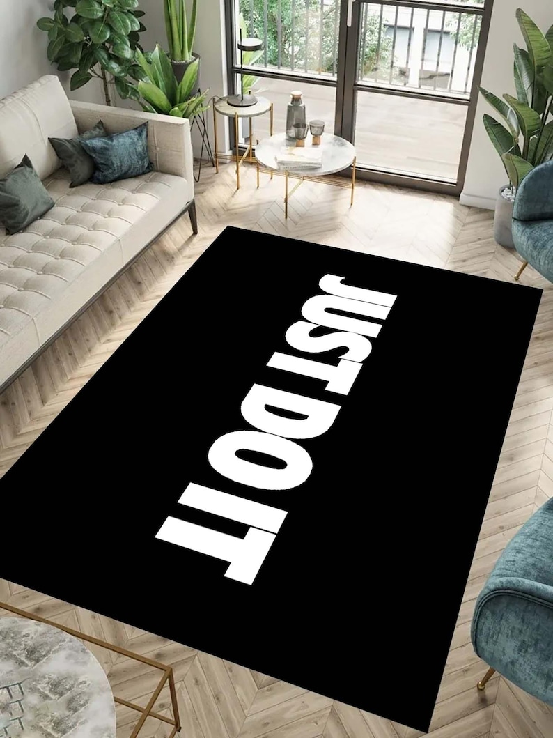 May include: Black and white rug with the text "Just Do It" in white letters on a black background.