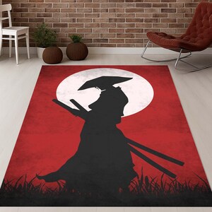 May include: A rectangular rug with a black samurai warrior silhouette set against a red background and a large white moon. The design includes stylized grass at the bottom. Suitable for a living room or bedroom.
