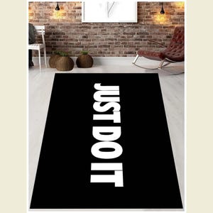 May include: Black and white rug with the text "JUST DO IT" printed in white on a black background.