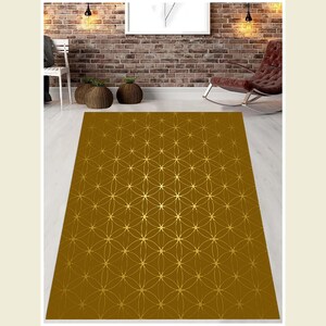May include: A brown area rug with a gold geometric pattern. The pattern is a repeating design of overlapping circles and stars.