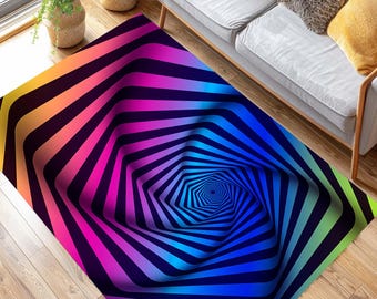 May include: A rectangular area rug with a vibrant, colorful, optical illusion design. The rug features a central hexagonal pattern with radiating stripes in shades of yellow, orange, pink, blue, and green, creating a 3D effect. The rug is placed on a wooden floor.