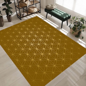 May include: A brown area rug with a geometric pattern of gold circles and lines. The rug has a subtle sheen and is perfect for adding a touch of elegance to any room.