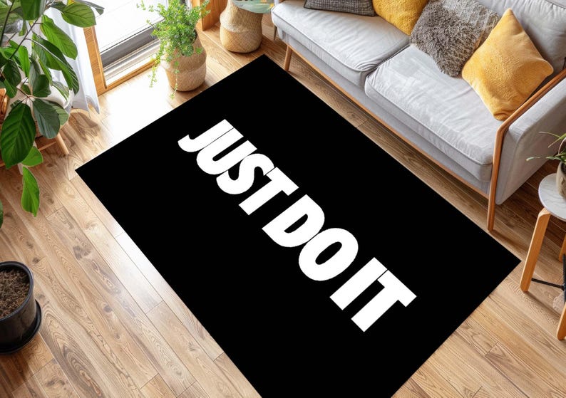 May include: Black and white rug with the text "JUST DO IT" in white letters.