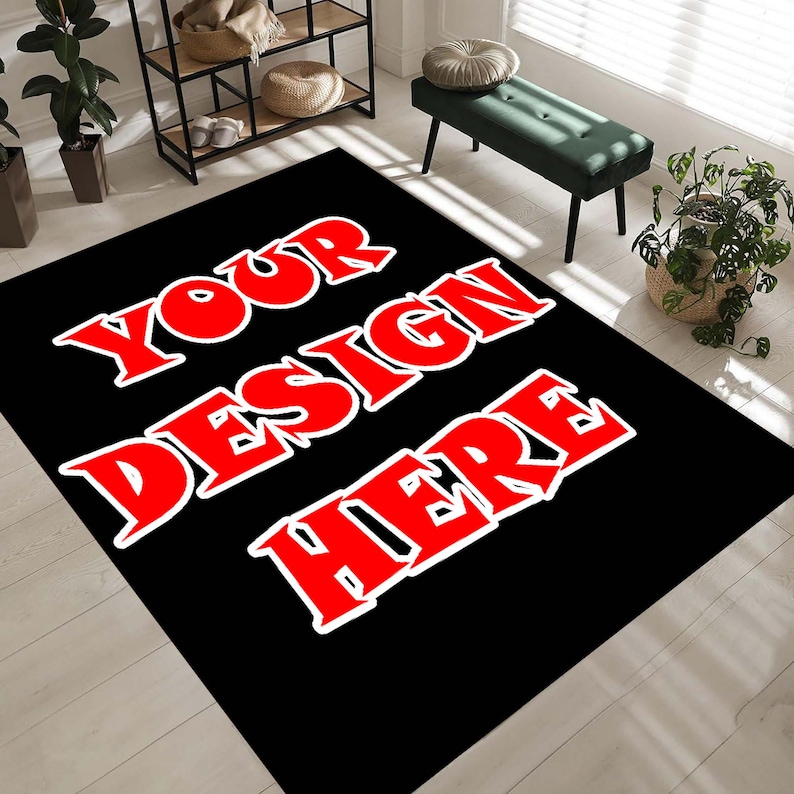 May include: Black rectangular rug featuring the text "YOUR DESIGN HERE" in large red letters with a white outline. The rug is placed on a light wood floor, with a green bench and plants in the background.