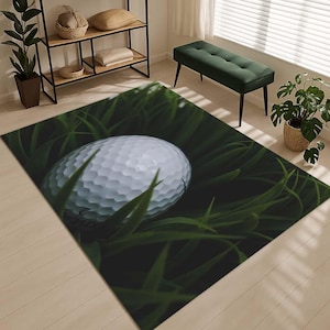 May include: A white golf ball resting on a bed of green grass. The ball is partially obscured by the blades of grass.