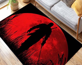 May include: A black and red rug with a silhouette of a person holding a sword in front of a large red moon.