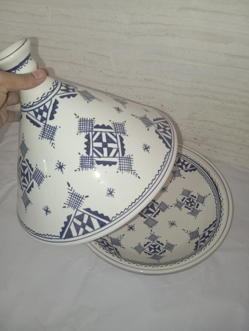 Moroccan Tajine: A masterpiece of traditional ceramic craftsmanship, this hand-painted clay cooking vessel represents the pinnacle of Berber culinary heritage.