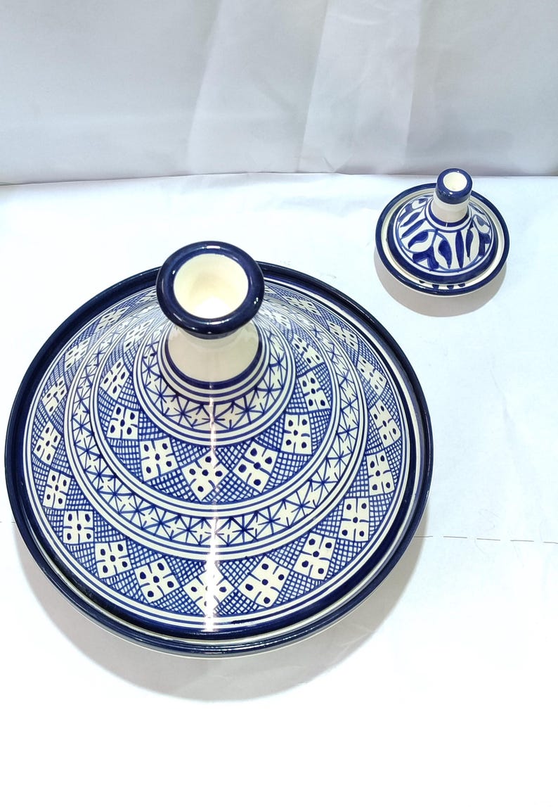 Crafted from high-quality ceramic, this Moroccan tagine combines functionality and elegance. The domed lid traps steam to infuse ingredients with robust flavors. Discover the art of Moroccan cooking with this versatile ceramic tagine.