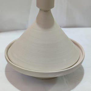 Bring the magic of Morocco to your kitchen with our handcrafted ceramic tagine, an authentic blend of culture and cuisine.Celebrate Moroccan heritage with a traditional ceramic tagine, beautifully designed for cooking or as a decorative centerpiece.