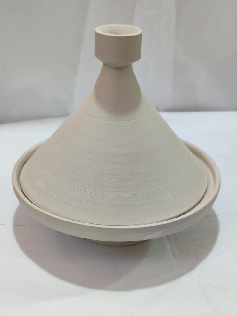 Bring the magic of Morocco to your kitchen with our handcrafted ceramic tagine, an authentic blend of culture and cuisine.Celebrate Moroccan heritage with a traditional ceramic tagine, beautifully designed for cooking or as a decorative centerpiece.