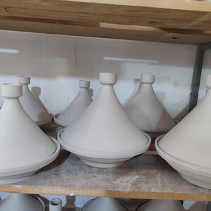 Explore the flavors of Moroccan cuisine with this traditional tajine. Designed for both cooking and serving, the ceramic tagine features a masterfully crafted domed lid and a wide, shallow base decorated with intricate patterns.