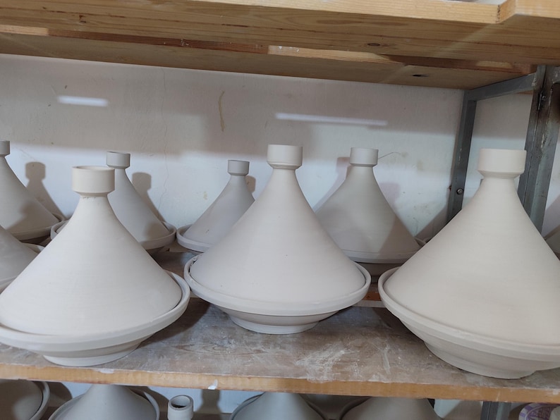 Explore the flavors of Moroccan cuisine with this traditional tajine. Designed for both cooking and serving, the ceramic tagine features a masterfully crafted domed lid and a wide, shallow base decorated with intricate patterns.