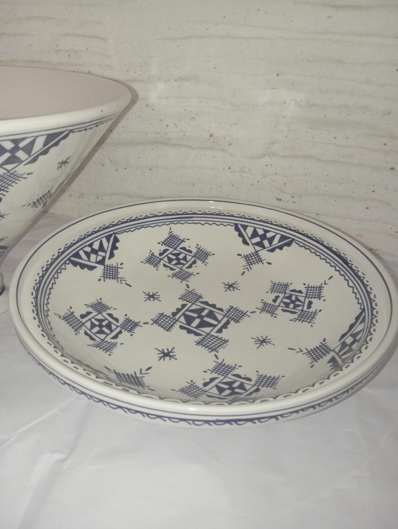 Handcrafted Moroccan Ceramic Tajine: A stunning fusion of culinary tool and artistic expression, this clay cooking pot showcases the incredible craftsmanship of Moroccan potters. With its intricate hand-painted designs and traditional shape,