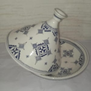 Traditional Berber Tajine: Expertly crafted by skilled artisans, this ceramic cooking pot represents the heart of Moroccan culinary culture. Each handmade tajine is a unique piece of pottery that combines functionality with artistic expression,