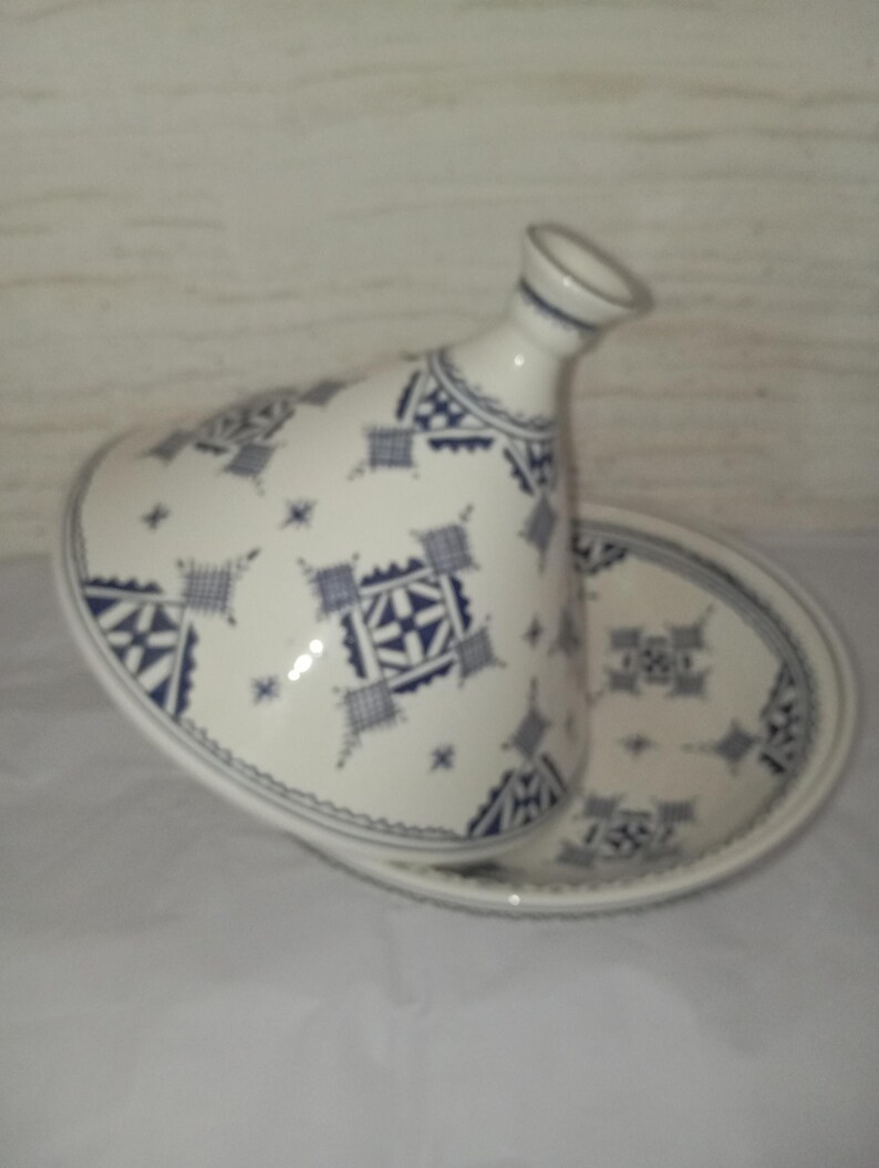 Traditional Berber Tajine: Expertly crafted by skilled artisans, this ceramic cooking pot represents the heart of Moroccan culinary culture. Each handmade tajine is a unique piece of pottery that combines functionality with artistic expression,