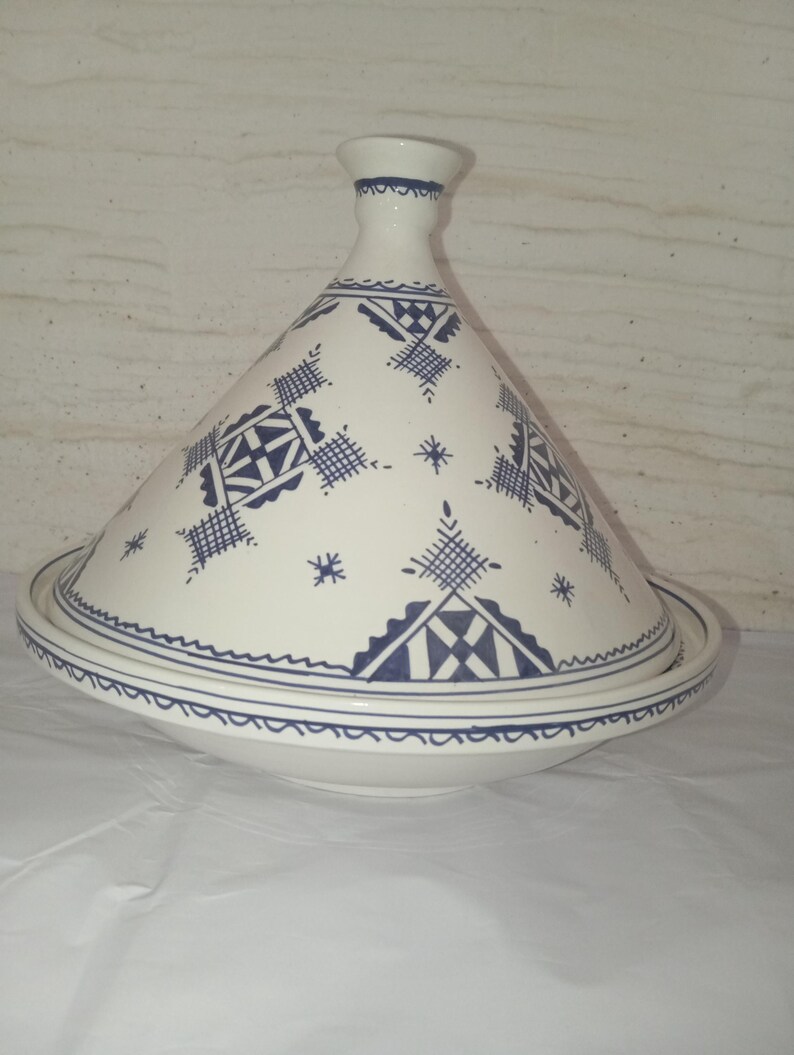 Antique-Style Moroccan Tajine: A magnificent representation of traditional kitchenware, this handmade ceramic pot embodies the soul of Moroccan cooking. Its unique design allows for slow, even cooking that preserves the natural flavors