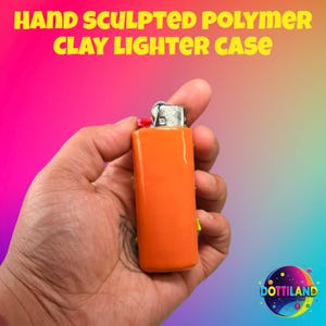 May include: Hand-sculpted polymer clay lighter case in bright orange. The lighter case has a glossy finish and a silver metal top. The text "HAND SCULPTED POLYMER CLAY LIGHTER CASE" is displayed in yellow. The lighter is held in a hand.