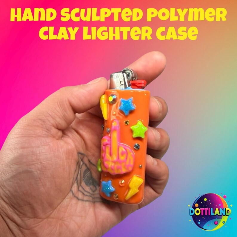 May include: Orange polymer clay lighter case with colorful star, lightning bolt, and middle finger designs. The text "HAND SCULPTED POLYMER CLAY LIGHTER CASE" is at the top. The lighter case is held in a hand.