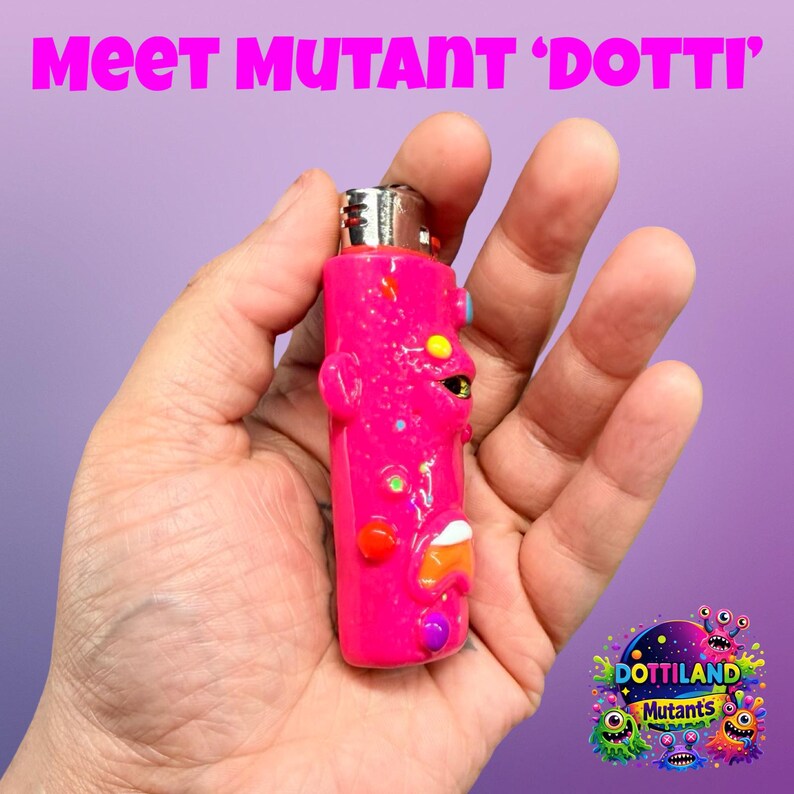 May include: A vibrant pink lighter, adorned with cartoon-style decorations, is held in a hand. The lighter features a silver metal top and is embellished with diverse shapes and colours. The text "Meet Mutant 'Dotti'" is displayed at the top of the image.