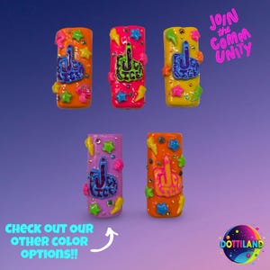 May include: A collection of colorful, rectangular accessories with a raised middle finger design. The accessories are decorated with stars, lightning bolts, and other shapes. The text "Join the Community" and "Check out our other color options!!" are also visible.