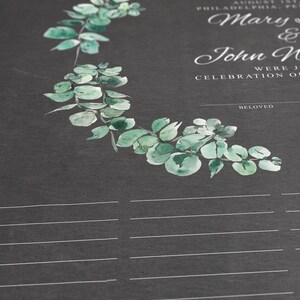 May include: A dark gray wedding guest book page featuring a watercolor eucalyptus wreath in shades of green. The text reads: Before family and, August 1st, Philadelphia, PA, Mary & John N, were j, celebration o, and beloved. Below the text are horizontal lines.