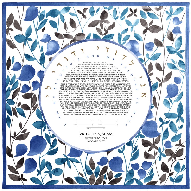 May include: A watercolor ketubah with a blue and gray floral design. The ketubah is a Jewish marriage contract and features the Hebrew text "And my beloved is mine and I am his." The text also includes the names Victoria and Adam, the date October 20, 2018, and the location Brookfield, CT.