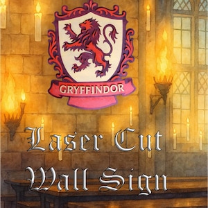 May include: A laser-cut wall sign featuring the Gryffindor house crest from the Harry Potter series. The crest, with a red lion, is set against a white background with a purple border. The sign is displayed on a brick wall.