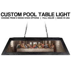 May include: Black rectangular pool table light fixture with a painting of The Last Supper. The fixture is suspended by two black chains. Text on the image reads: CUSTOM POOL TABLE LIGHT, CHOOSE FROM 3 WOOD STAIN OPTIONS | FULL COLOR | MADE IN USA.
