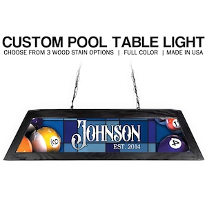 May include: Custom pool table light with a black frame, hanging from chains. The light features a blue and white background with the name "Johnson" and "EST. 2014". Billiard balls are visible on the sides.