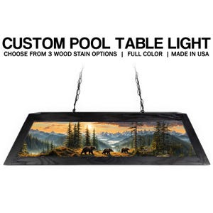 May include: A rectangular pool table light fixture with a black frame and a landscape painting of a mountain scene with bears. The text "CUSTOM POOL TABLE LIGHT" is at the top.