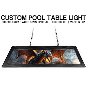 May include: Black rectangular pool table light fixture with a dragon image. The fixture is suspended by chains and has the text "CUSTOM POOL TABLE LIGHT" and "CHOOSE FROM 3 WOOD STAIN OPTIONS | FULL COLOR | MADE IN USA".