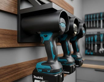 May include: Three black and teal cordless drills are mounted on a black metal rack attached to a wooden wall. The drills are labeled "Makita" and "18V Lithium Ion". The background includes a tool rack and a gray wall.