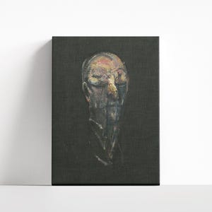 May include: A white ceramic mug with a black handle and the text "But First, Coffee" in a bold, black font. The mug is set against a blurred background, suggesting a cozy setting.