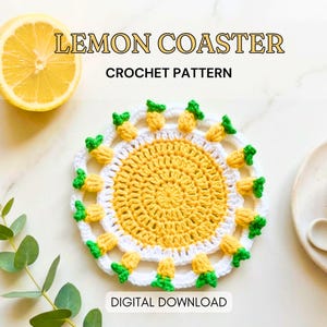 May include: A crocheted lemon coaster with a yellow center and white and yellow pineapple-shaped edging. A sliced lemon and a cup of tea are also in the image. The text "LEMON COASTER CROCHET PATTERN" is displayed.