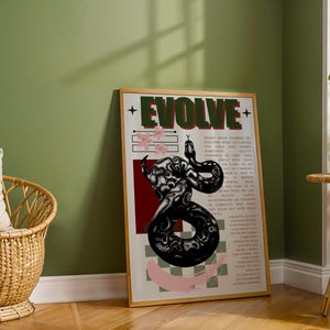 May include: A framed poster with the word "EVOLVE" in green and red text. The poster features a black and white illustration of a snake, pink floral accents, and additional text. The background is a mix of red, white, and black checkered patterns.