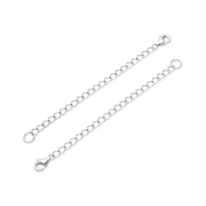 May include: Two silver extender chains with lobster claw clasps. Each chain is approximately 2 inches long.