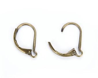 May include: Two gold-toned earring hooks with a spring-loaded closure. The hooks are made of metal and have a smooth finish.