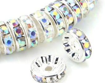 May include: Silver-toned bead with a row of iridescent rhinestones around the edge. The bead has a small hole in the center for stringing.