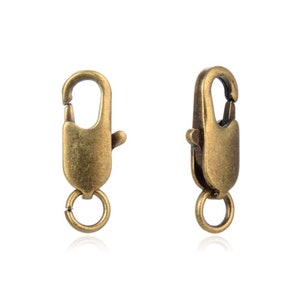 May include: Two antique gold-toned metal lobster claw clasps with jump rings.