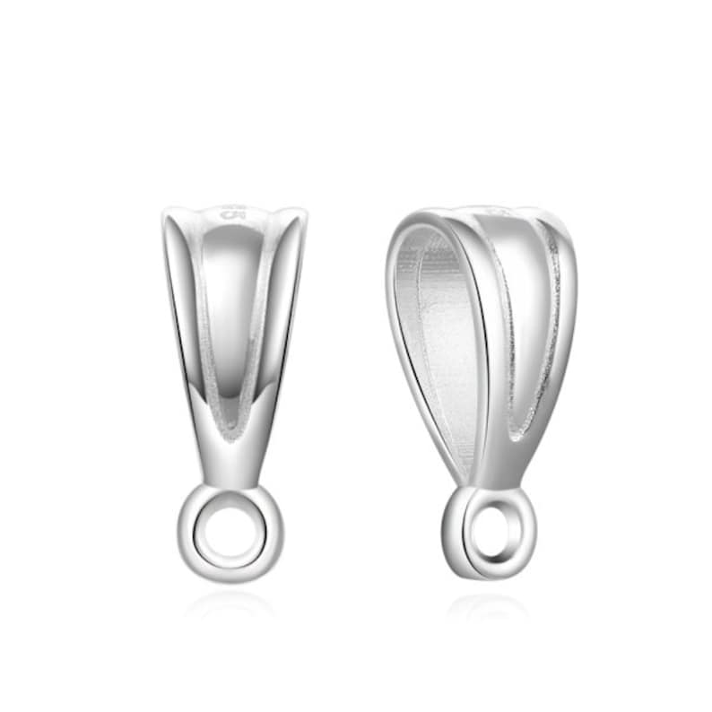 May include: Two silver pendant bails with a loop at the bottom. The bails are designed to hold a pendant or charm.