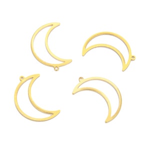 May include: Four gold metal crescent moon shaped charms with jump rings.