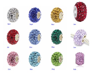May include: Twelve silver charm beads with a crystal design, each bead representing a different month of the year. The beads are arranged in three rows of four beads each. The beads are all the same size and shape, and they are all covered in small, sparkling crystals. The beads are a popular choice for jewellery making and are often used to create bracelets, necklaces, and earrings.