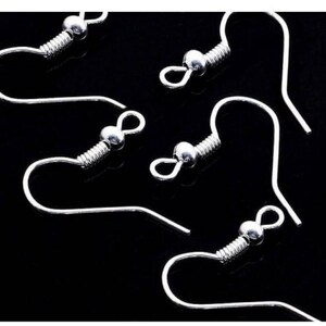 May include: Five silver earring hooks with a spring coil and a small ball at the top.