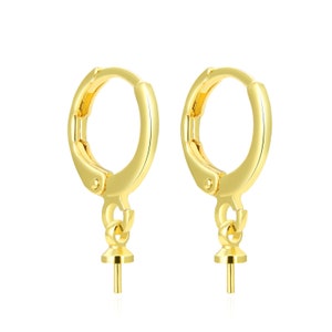 May include: A pair of gold-toned hoop earrings with a small, round, pearl-sized post hanging from each hoop.